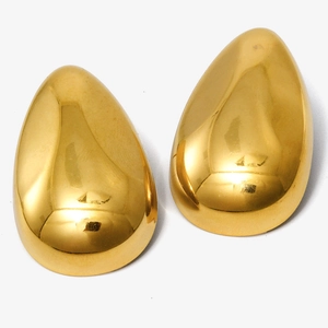 Macro detail of the smooth 18k gold plated water drop earrings with polished surface
