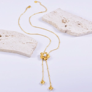 Golden Y-shaped necklace with flower pendant, pearl core and heart tassel charms