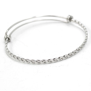 Macro shot of silver twisted metal bracelet with adjustable open rope coil design