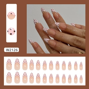 Pink French press on nails with black dots in a long almond shape, 24 piece nail kit