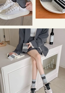 Detailed close-up of grey and white striped crew socks in a cozy minimalist setting