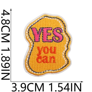 Detailed view of yellow 'YES YOU CAN' embroidered patch with 4.8cm x 3.9cm dimensions
