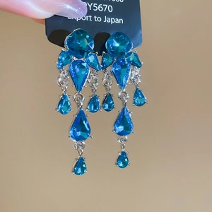 Close-up of blue crystal water drop tassel earrings with sparkling rhinestone detail