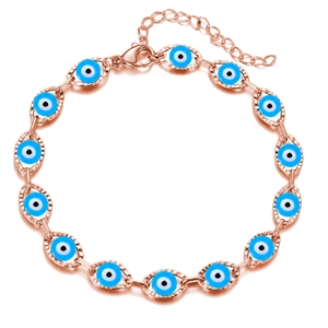 Macro detail of rose gold evil eye bracelet with blue charms and lobster clasp