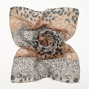 Close-up of lightweight chiffon leopard print scarf with soft textures and draped layers