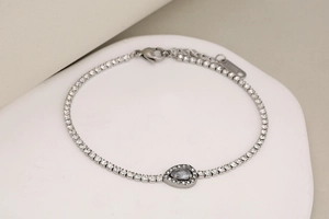 Macro shot of silver stainless steel chain bracelet with water drop grey gemstone