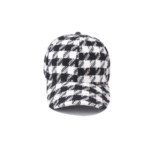 Detailed texture of thick houndstooth plaid baseball cap with black and white pattern