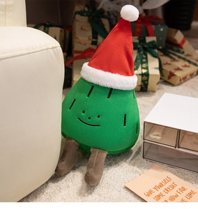 Close-up of plush Christmas tree doll with soft green fur and a festive red hat