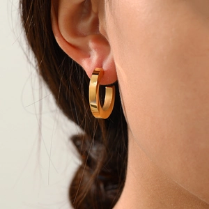 Close-up of minimalist 14K gold plated geometric stainless steel hoop earrings on model