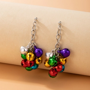 Macro shot of colorful Christmas bell earrings with vibrant metallic charms and chain links