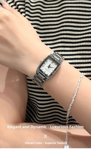 Close-up of rectangular silver quartz watch with steel band and matching beaded bracelet