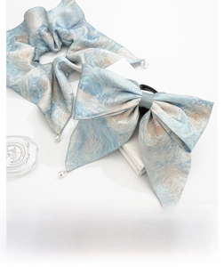 Close-up of starry night tie-dye scrunchie and bow hair clip with white pearl pendants