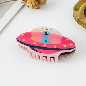 Pink UFO hair claw clip with blue alien design in glossy acetate for creative hair styling