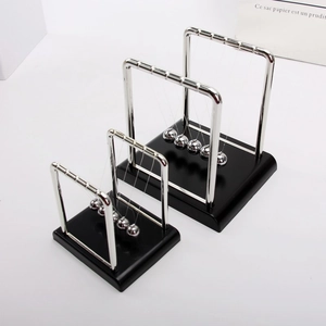 Three sizes of Newton's Cradle collision balls with metal frame and black base