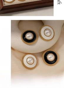 Detail view of vintage round stud earrings with pearl centers and braided gold texture
