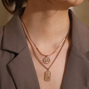 Double-layered gold star and moon necklace with tarot square pendant on a female model