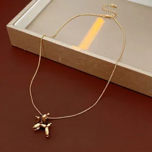 Gold-plated balloon dog pendant necklace with tiger eye stone beads on a chain
