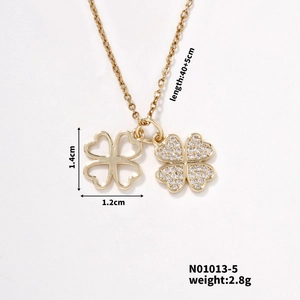 Detail of gold clover necklace showing pavé cubic zirconia and hollow motif pendant
