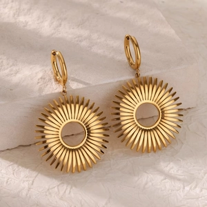 Chic 18K gold-plated hollow flower hoop earrings on a marble stone background