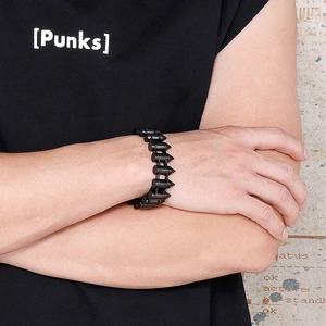 Close-up of black stainless steel bullet link chain bracelet on male wrist