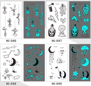 Luminous tattoo stickers showing glowing snake and butterfly patterns in dark conditions