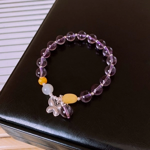 Close-up of S925 silver amethyst and jade bead bracelet with a metal butterfly charm
