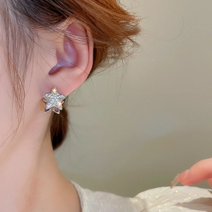 Elegant silver star hoop earrings with white zircon on model for minimalist style