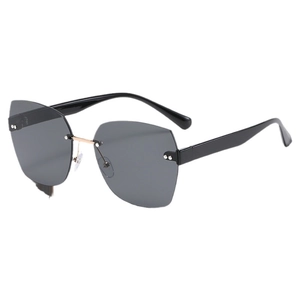 Frameless cat-eye sunglasses with grey lenses, gold bridge, and silver rivet accents