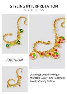 Detailed macro view of gold fruit pendants on stainless steel link bracelets
