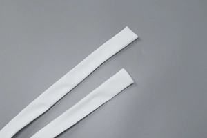 Close-up of white elastic straps and smooth fabric detail of the halter top
