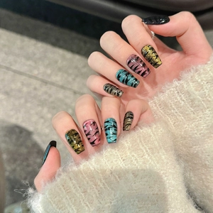 Glittering cat-eye press-on nails with tiger stripes in long coffin shape
