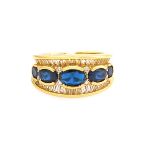 18K gold plated X-shaped ring with dark blue oval gemstones and cubic zirconia accents