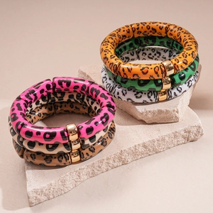 Detail view of 6-piece leopard print resin bamboo bracelets with gold metal clasps