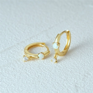 Detailed view of gold S925 sterling silver hoop earrings with white opal and zircon studs