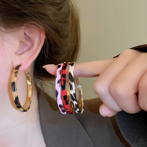 Close-up of leopard print hoop earrings in four colors with high-quality metal finish