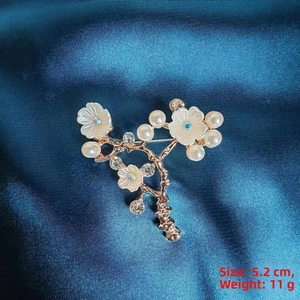 Detail of camellia brooch with pearls and crystals on blue silk, 5.2 cm and 11 g weight