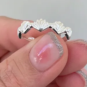 Macro shot of S925 sterling silver ring with shell pattern and hallmark engraving