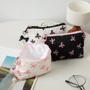 Three-piece pleated bow makeup bags with pearl zipper charms in stylish scene