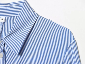 Close-up of blue and white striped shirt collar showing fabric texture and S size label