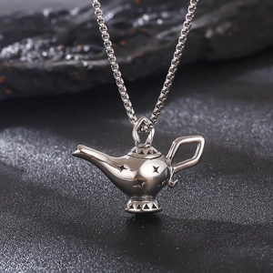 Macro shot of silver Aladdin lamp pendant in polished stainless steel on box chain