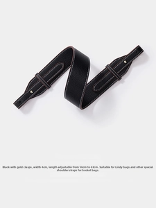 Detail of 4cm wide black lychee leather bag strap with gold buckle and contrast stitching
