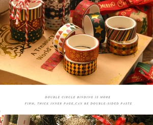 Close-up of gold-foil Christmas washi tape with snowflake patterns on vintage books