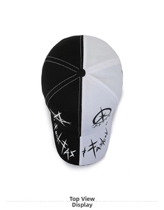 Top down view of a black and white split baseball cap with star and cross print