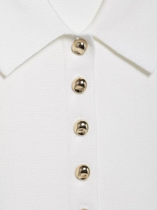 Detail of white ribbed knit cardigan with oversized gold dome buttons and sharp collar