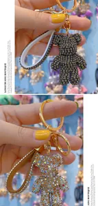 Detail of dark grey and iridescent crystal bear keychains with matching rhinestone straps