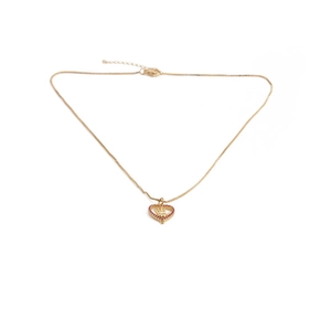 Detail of gold heart pendant with red crystal border and central palm charm on necklace