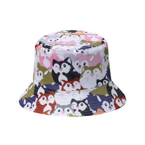 Close-up of vibrant cartoon cat and husky prints on a cotton canvas bucket hat