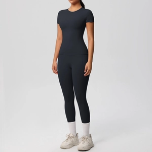 Detailed view of black high-elastic yoga set with slim fit top and leggings for fitness