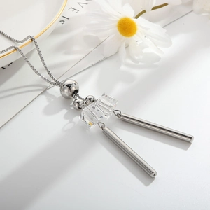 Detail of silver long sweater necklace featuring clear crystal beads and metal cylinders
