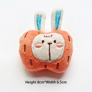 Macro detail of cute plush rabbit brooch with blue ears and dimensions 8cm by 6.5cm